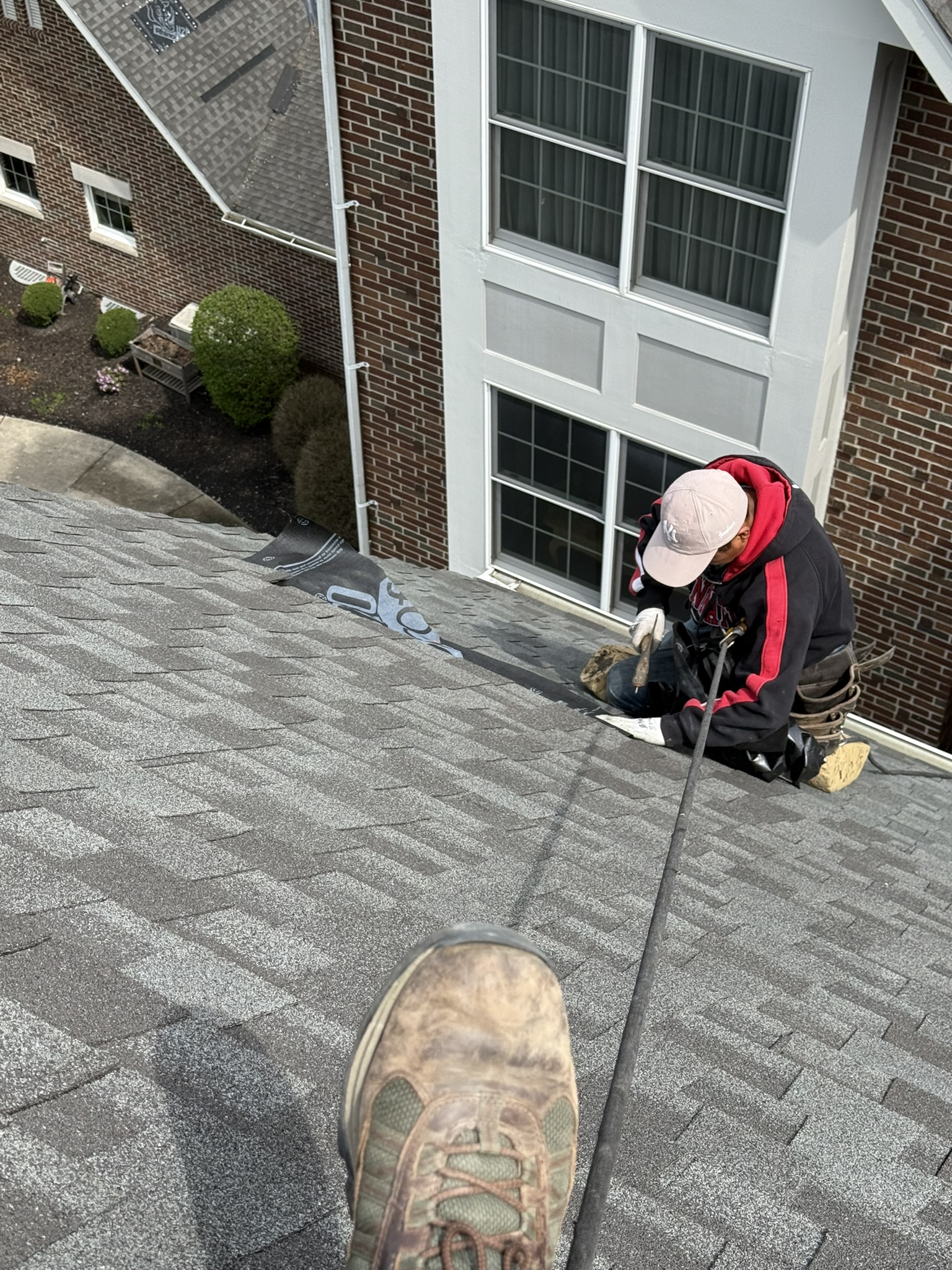 Roofing technician performing roof repair