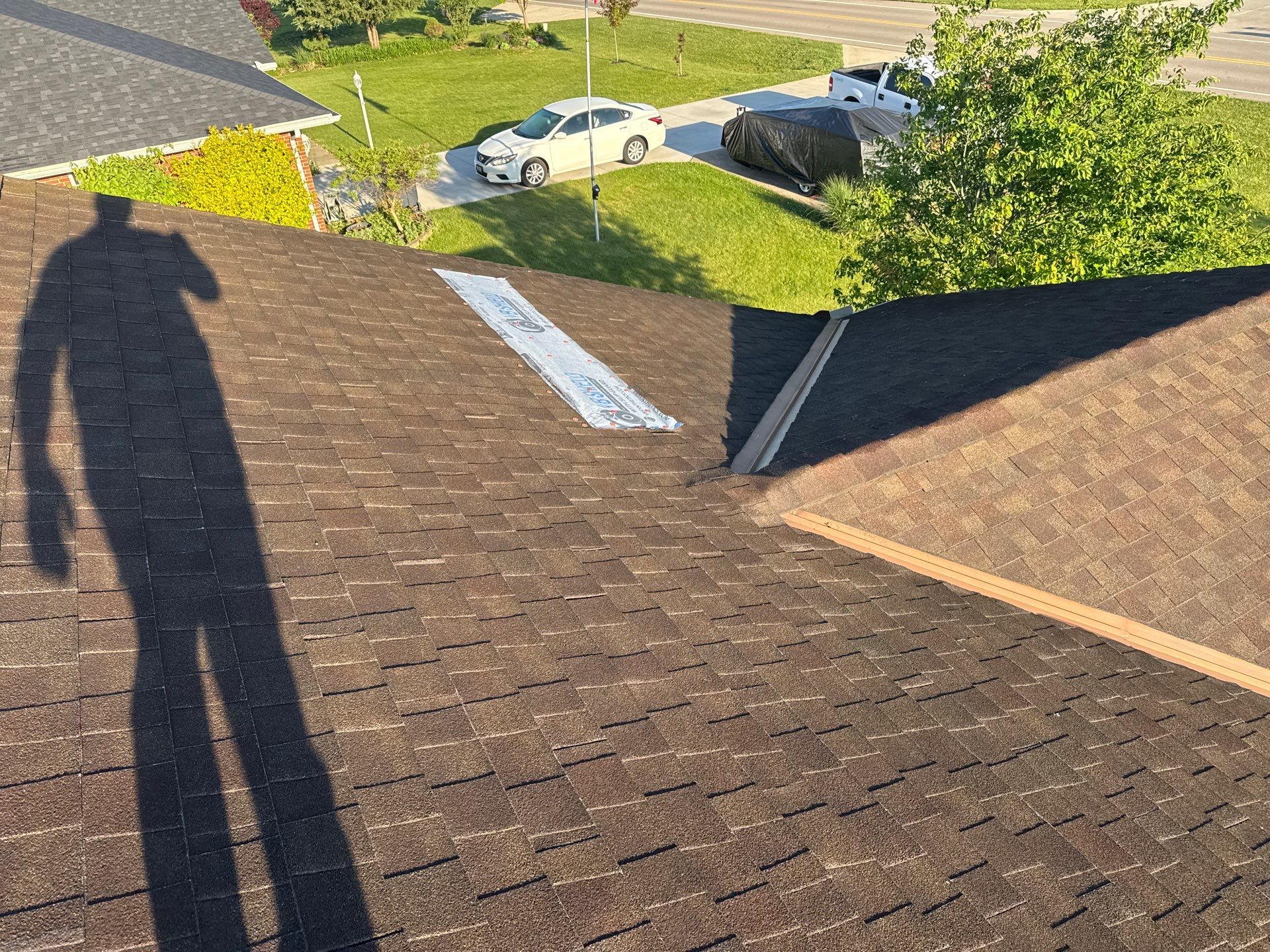 Missing shingles on a roof with a tarp over them in Columbus, OH